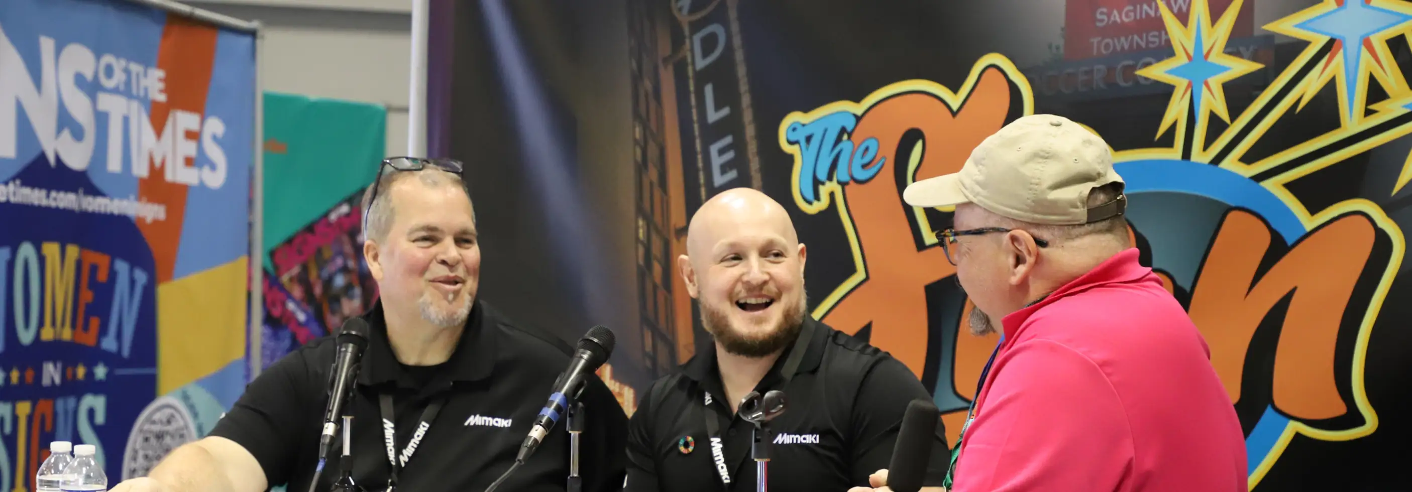 Three men talking at a table